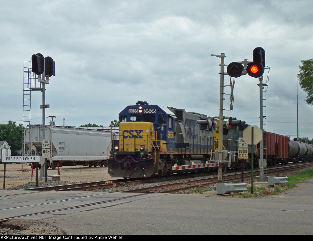 CSX 8636 passing the station sign WB on the BNSF